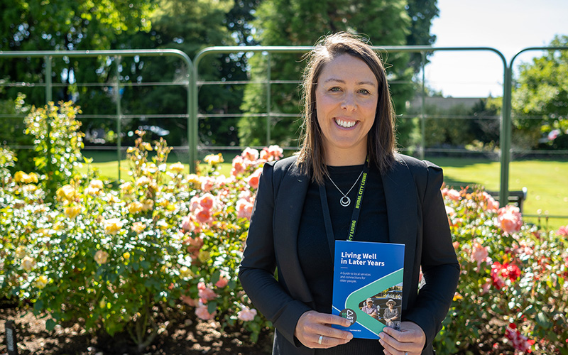 Photo of Suzie Bruce holding a copy of the booklet